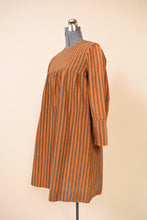 Load image into Gallery viewer, Late 1960s Orange Blue Green Stripe Silver Button Mini Dress By Marimekko, pictured front the side.
